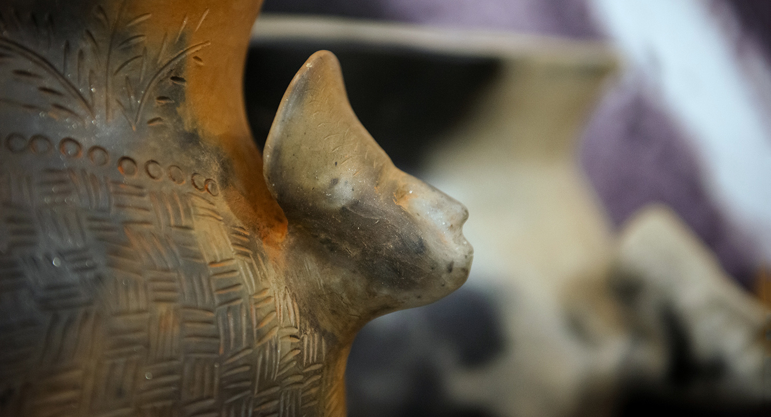 Close-up image of a piece of Catawba pottery with a Native American chief's head on the side