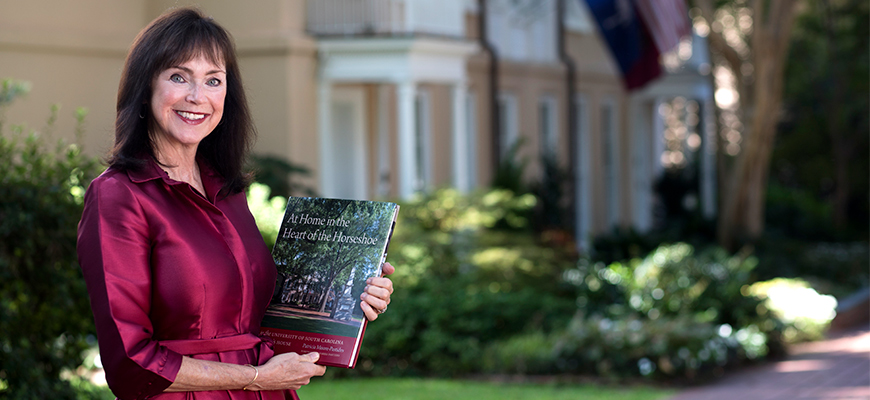 Patricial Moore-Pastides holding her book