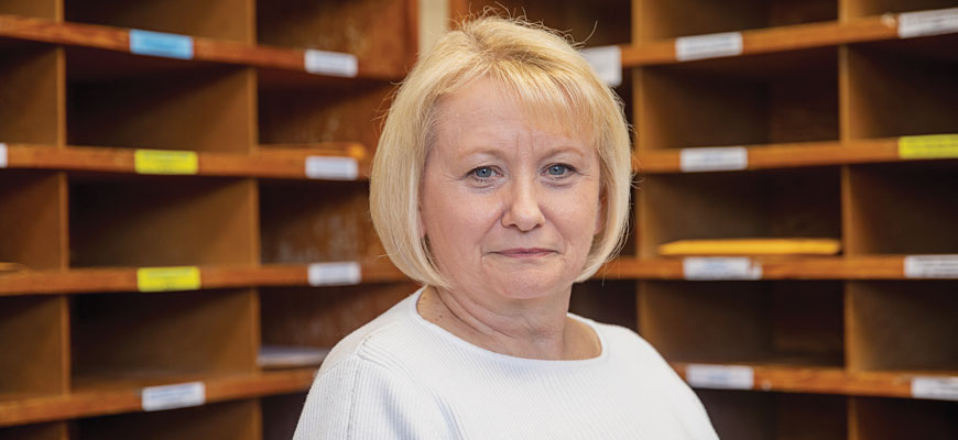 portrait of Sarah Kelly in mail room