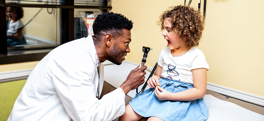 doctor examining child in office