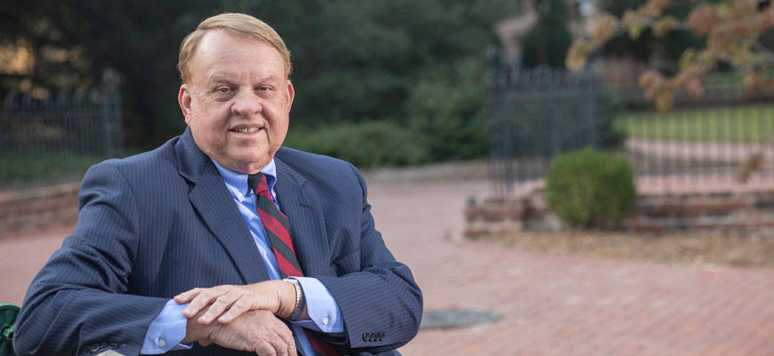 College of Arts and Sciences Dean Lacy Ford sits on a bench on the University of South Carolina campus