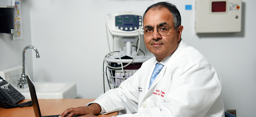 Rohit Talwani sitting at his desk