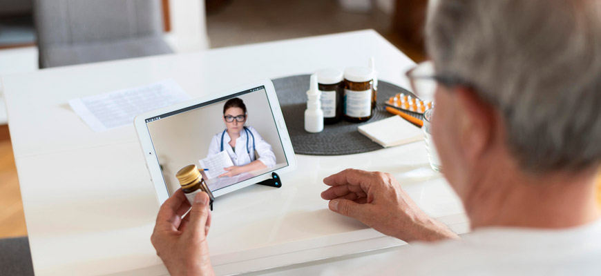 stock image of telehealth with doctor depicted on electronic device