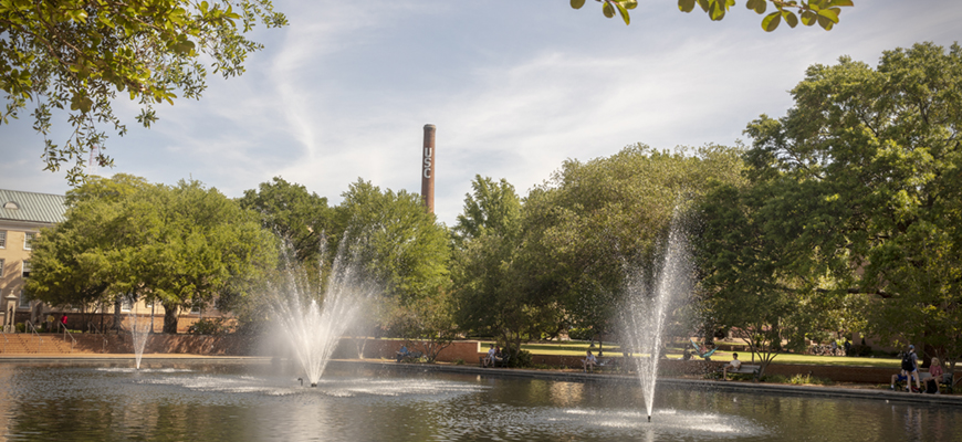 The USC smokestack rises about the Thomas Cooper Library fountain