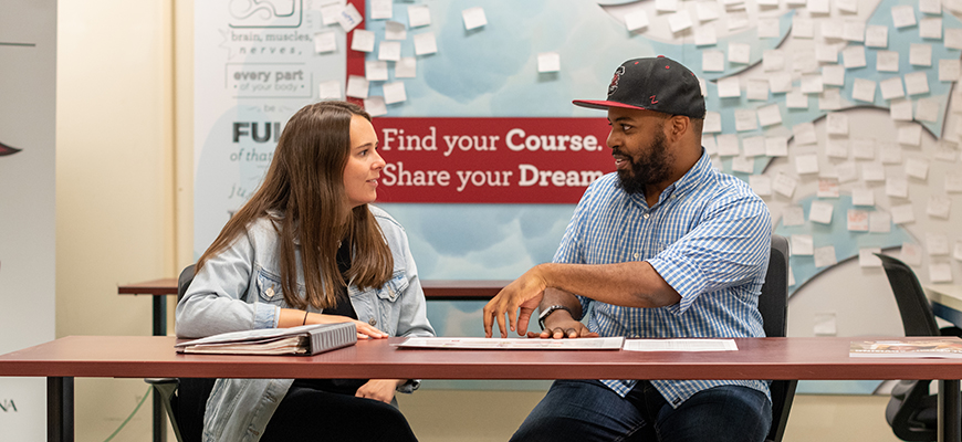 A UAC advisor works with a student.