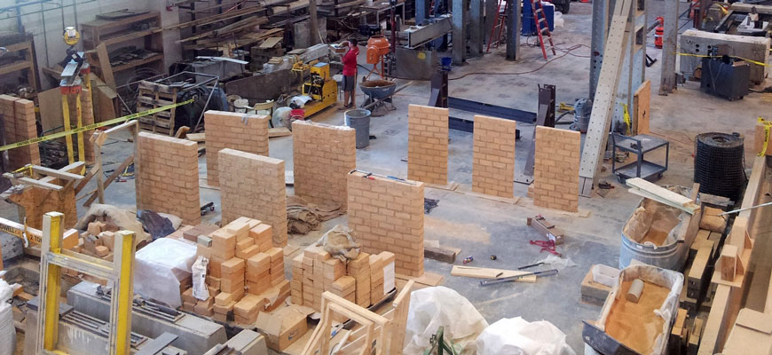 overview of room with earthen blocks being made