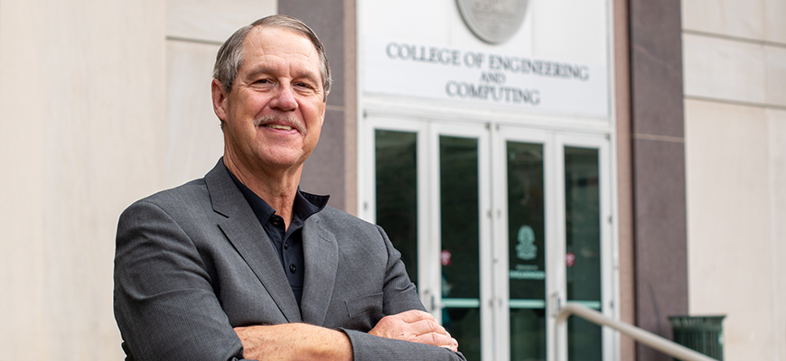 Michael Sutton stands in front of the UofSC College of Engineering and Computing.