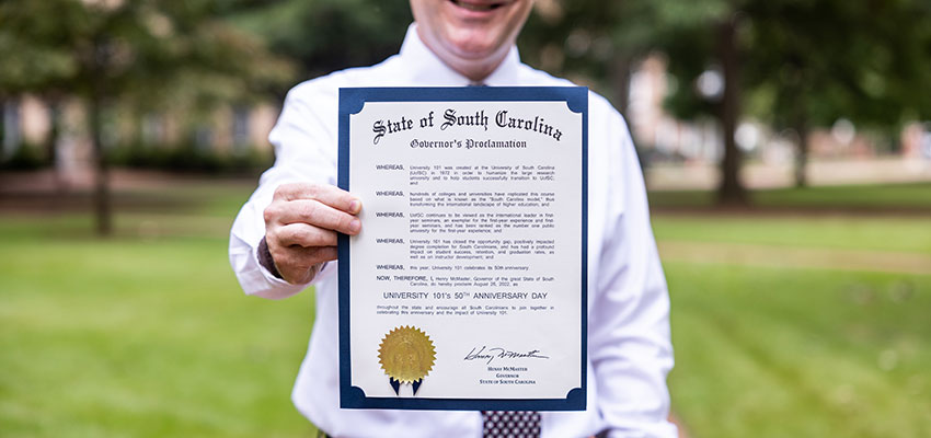 Dan Friedman holds a physical copy of the governor's proclamation on the Horseshoe