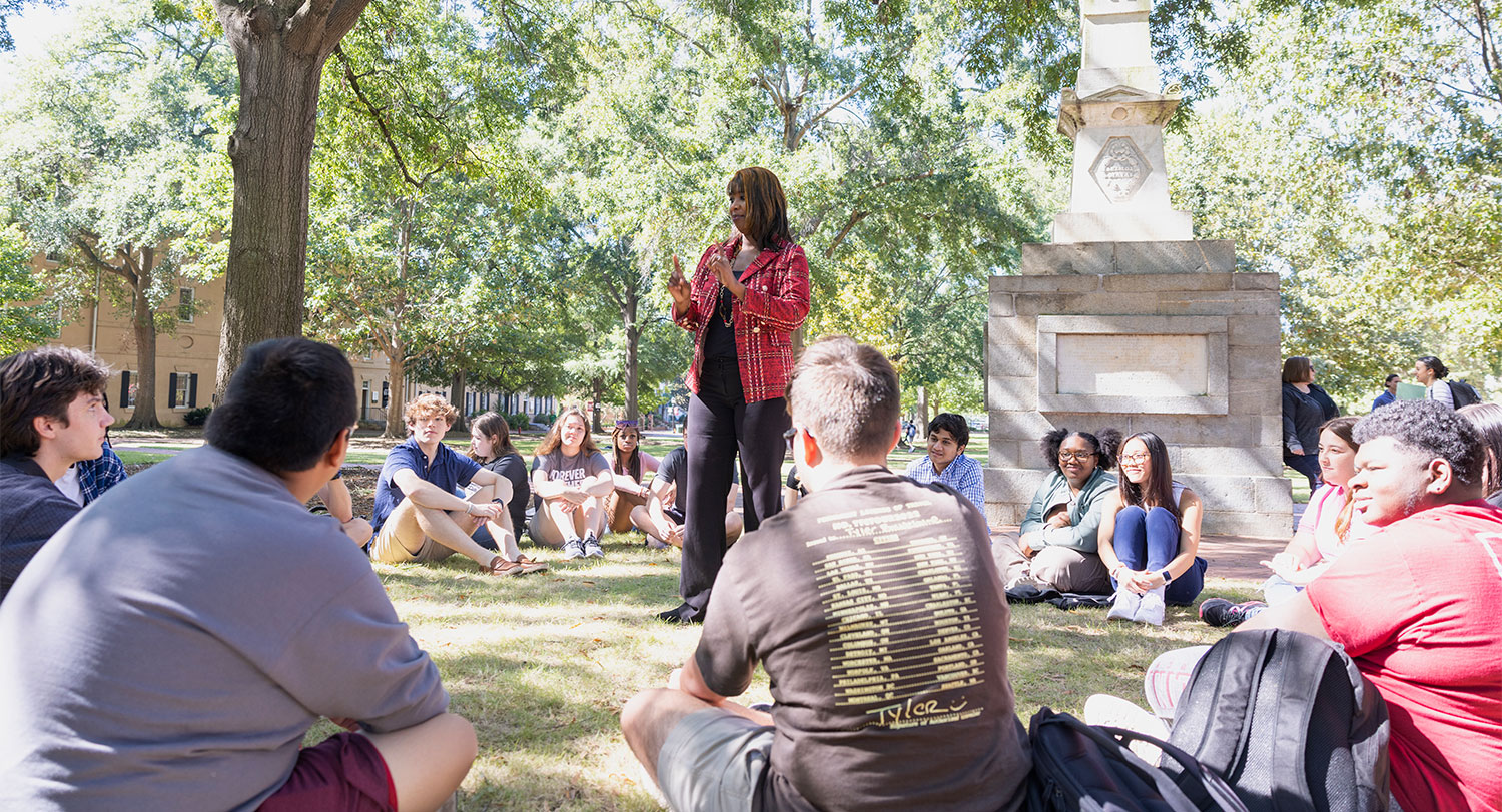 U101 professor talking to her class on the Horseshoe.