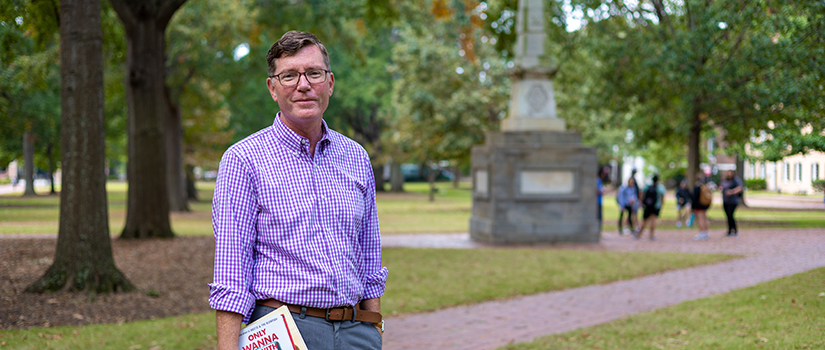 Michael McGandy holds books on the Horseshoe.