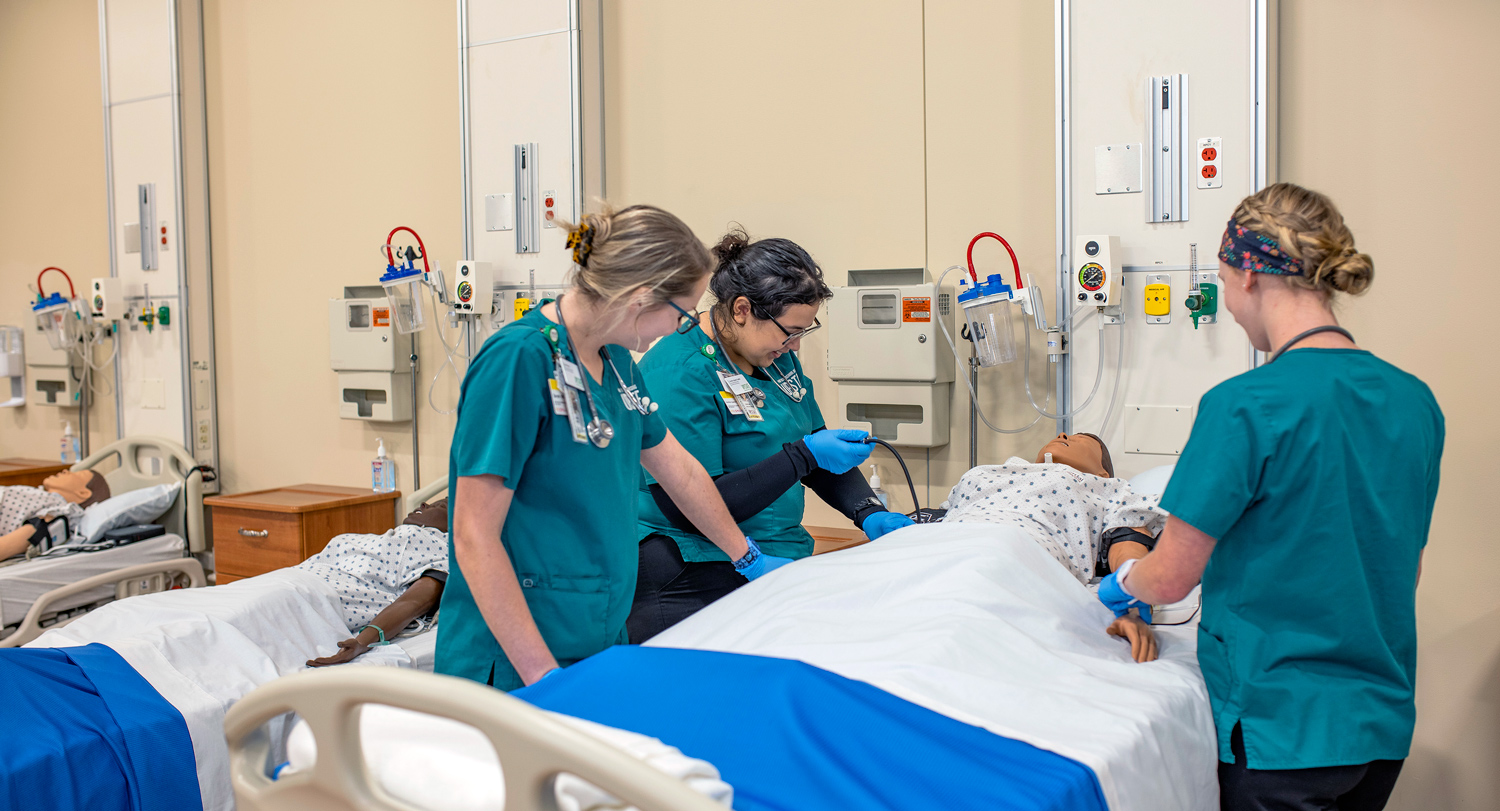 students work on a simulation patient in the USC Upstate nursing lab