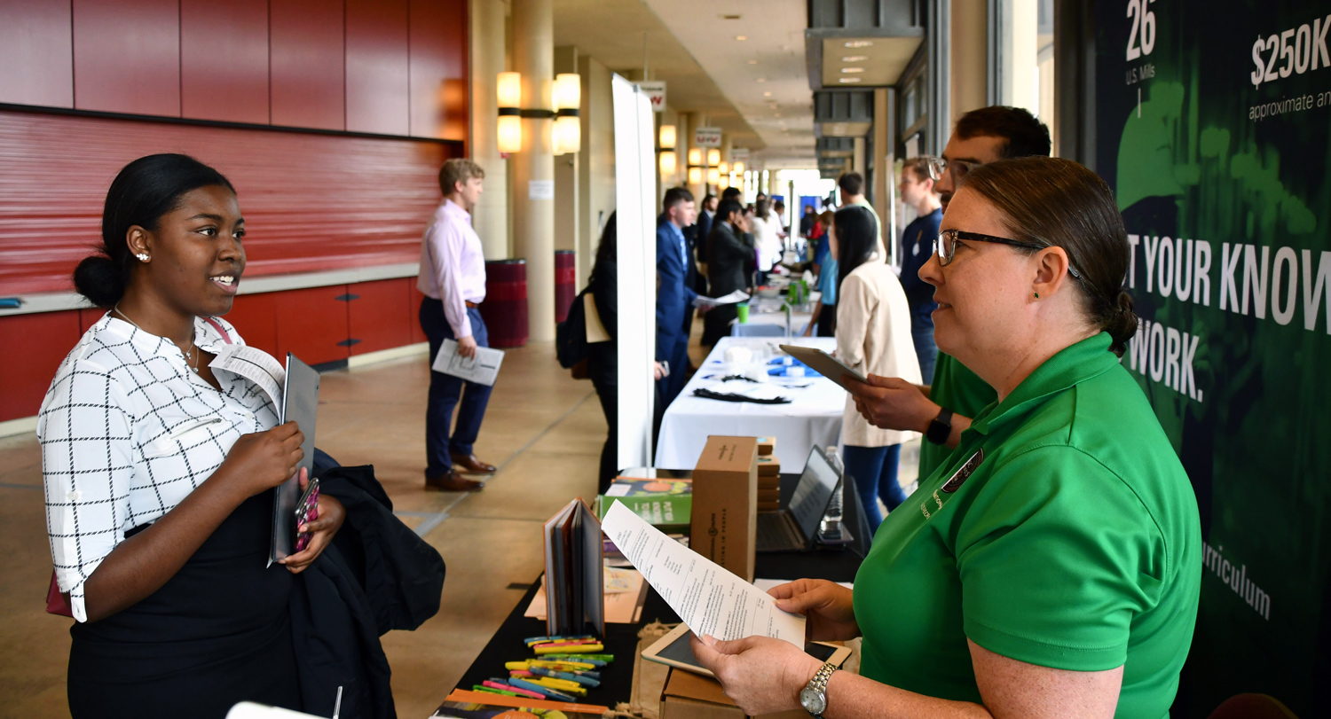 Student speaks to job recruiter at a career fair