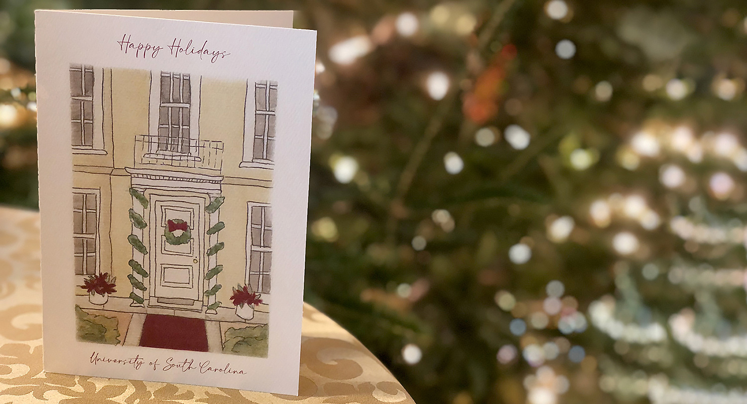 photo of a holiday card depicting a front door with decorations and the words Happy Holidays University of South Carolina on it