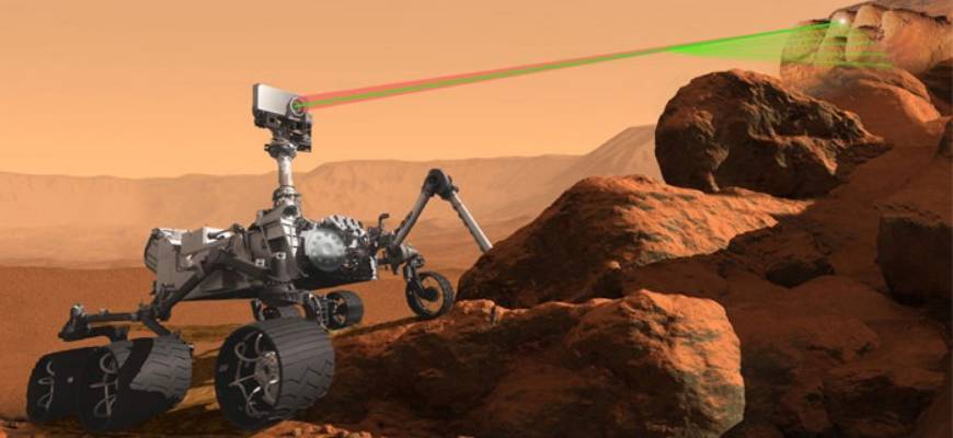 an artist's concept of the Mars rover analyzing rocks on Mars