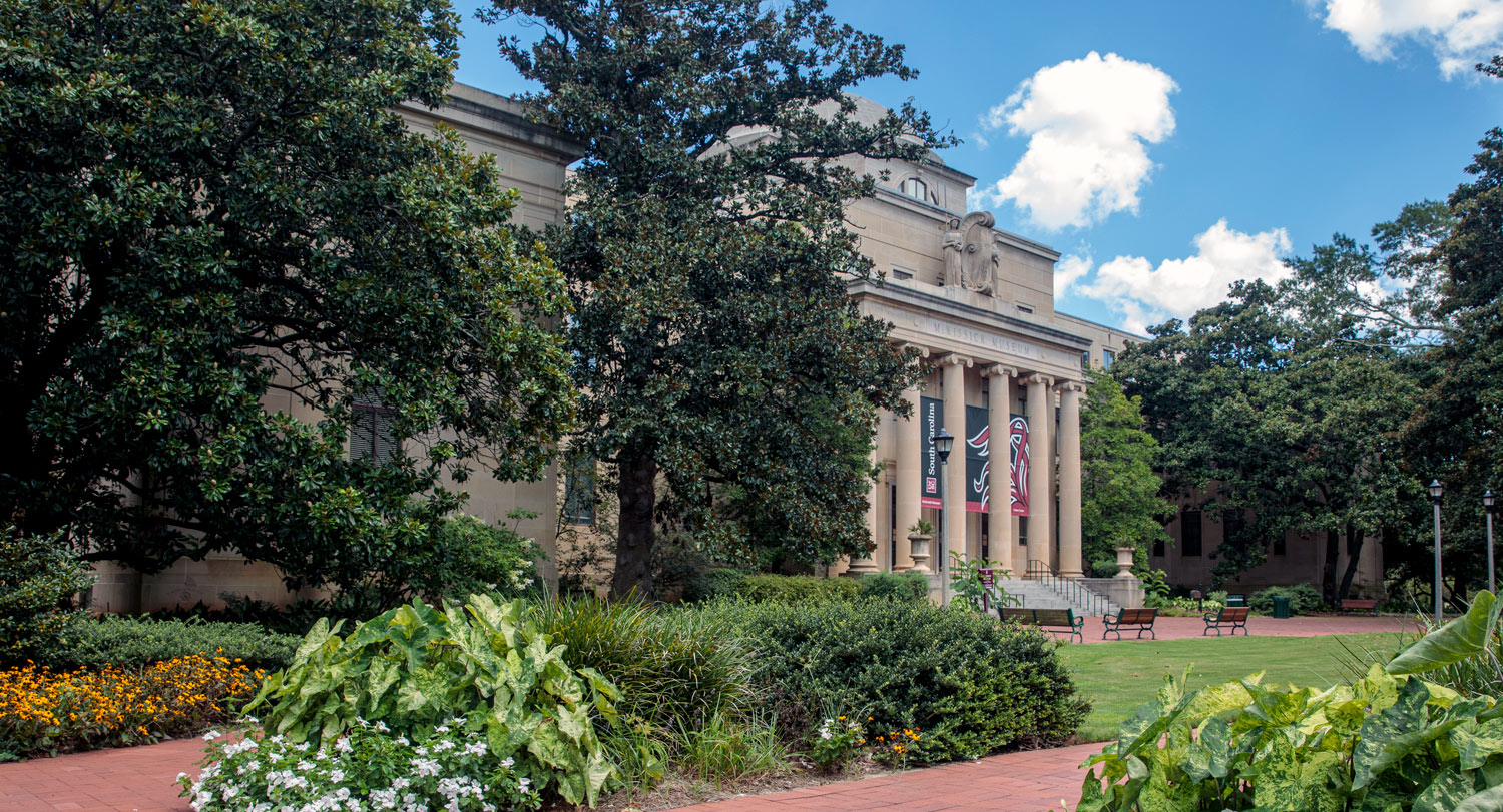 McKissick Museum surrounded by blooming plants and flowers