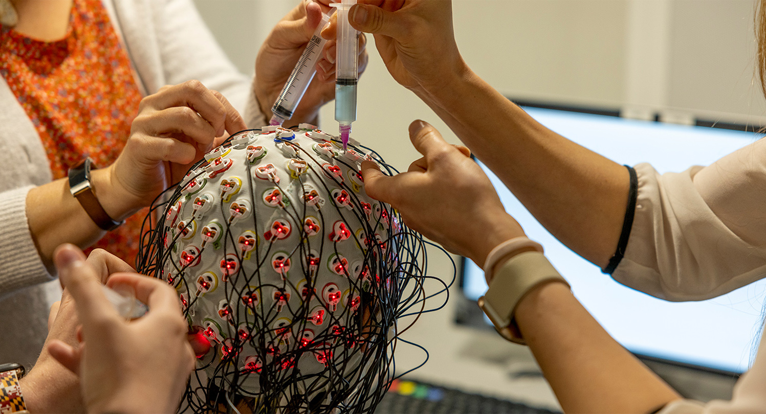 Brain research showing wires connected to a cap on a participant's head