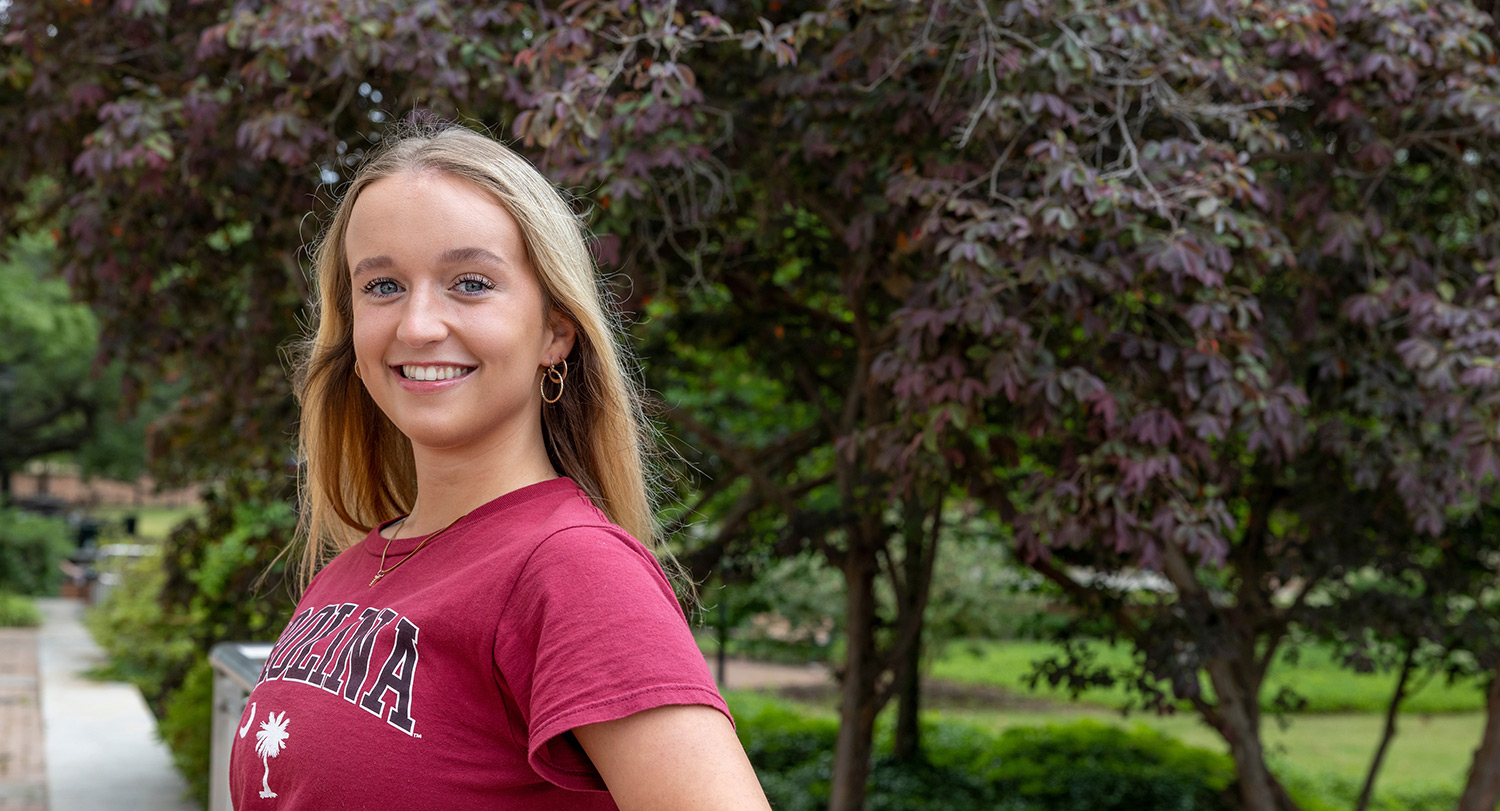 A photo of Tori Edsel leaning against a railing.