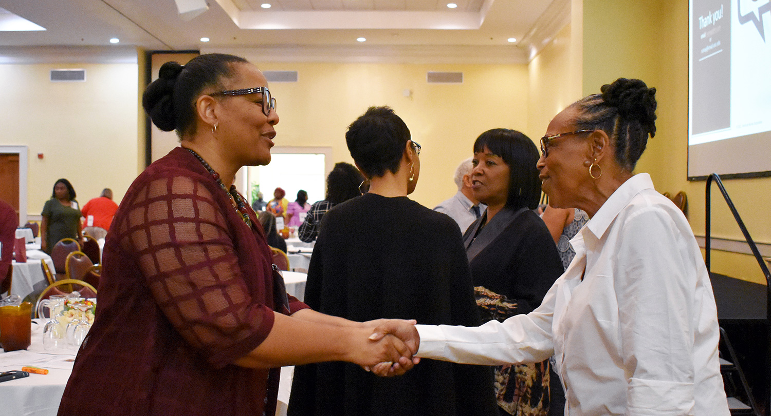 Two women shaking hands