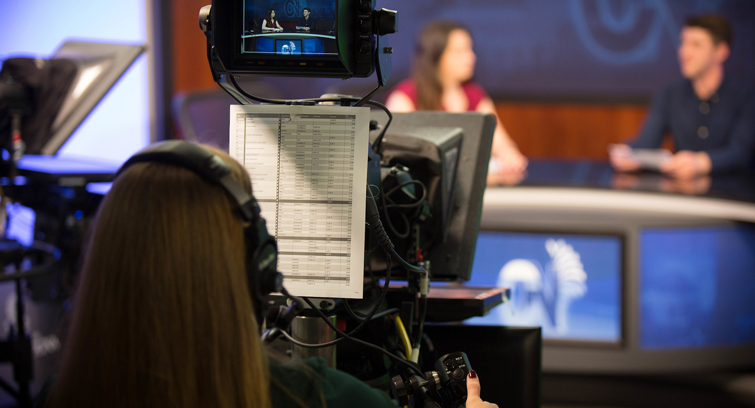 Person operating a television broadcast camera.