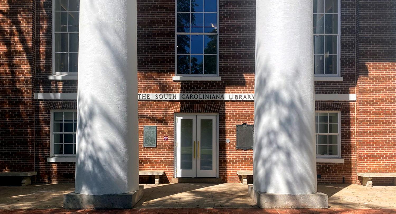 brick building with four large white columns and the words South Caroliniana Library