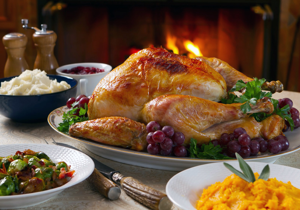 A dinner with a turkey is set on a table.