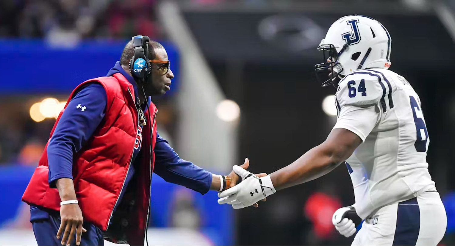 Jackson State Tigers coach Deion Sanders shakes hands with right tackle Deontae Graham