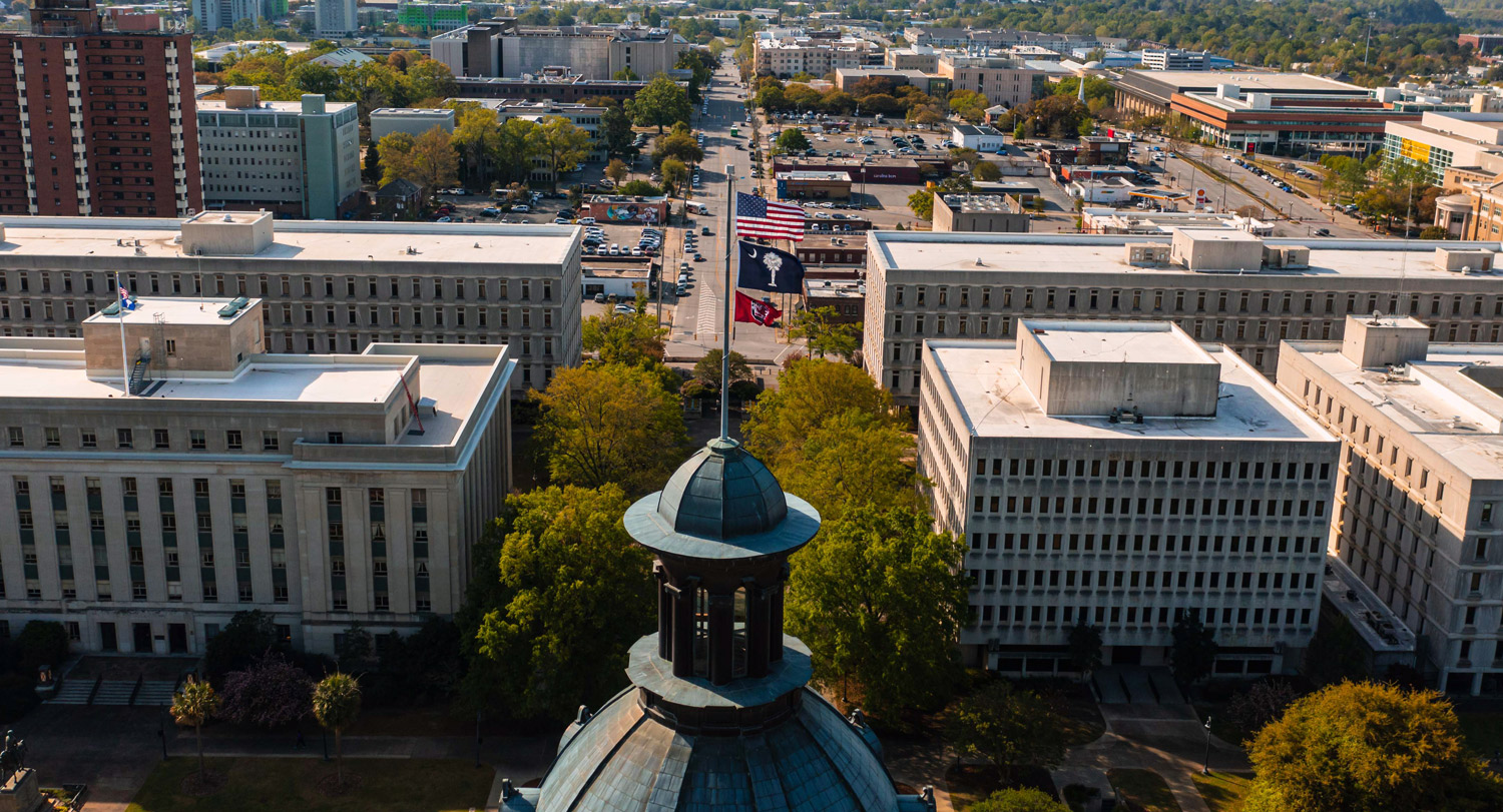 SC Statehouse dome with U.S., SC and USC flags flying atop it