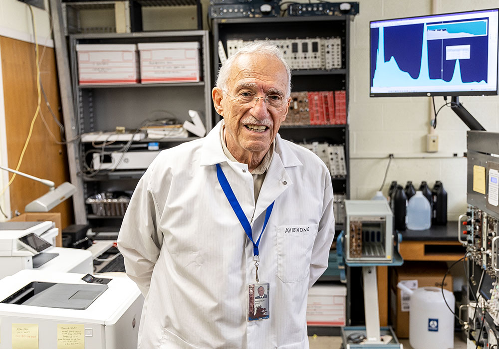 Frank Avignone poses in lab wearing a white lab coat.