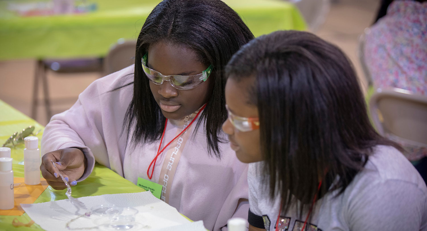 Students wear protective glasses while learning at camp