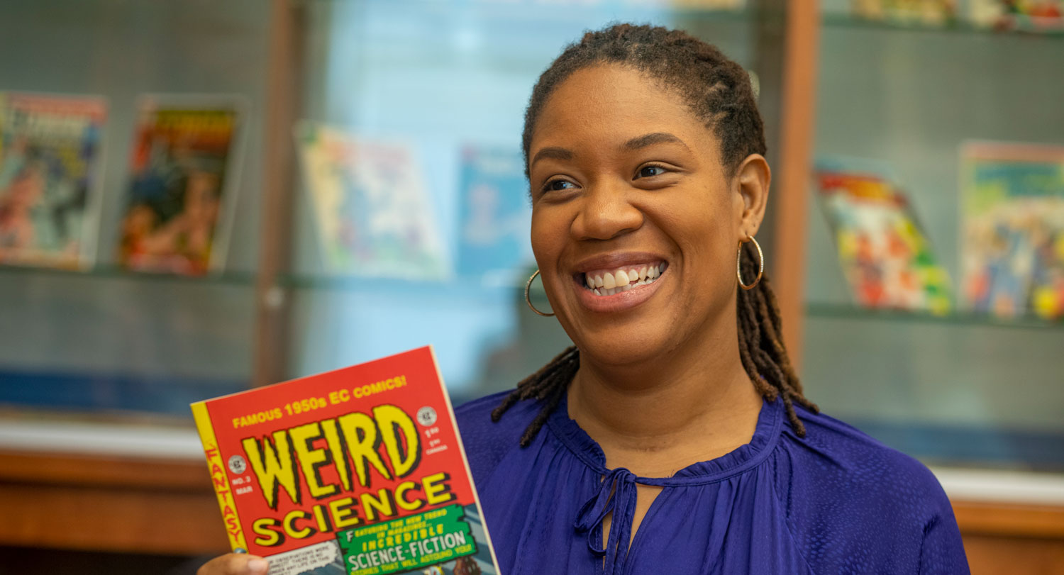 Qiana Whitted holds a comic book.