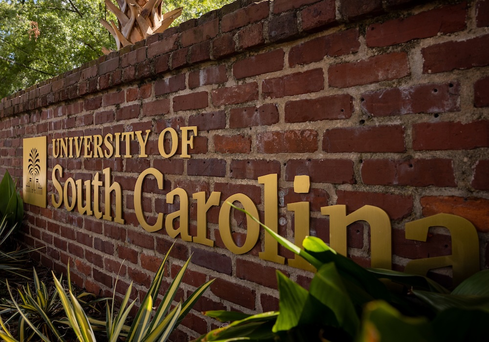 brick sign with gold letters reading University of South Carolina