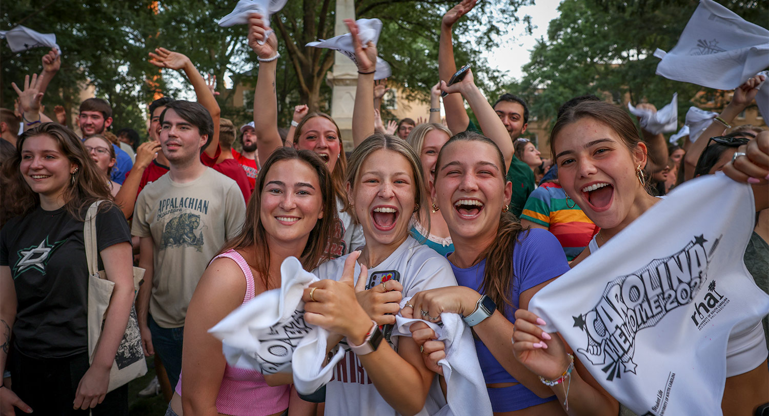 closeup of student faces on the horseshoe cheering