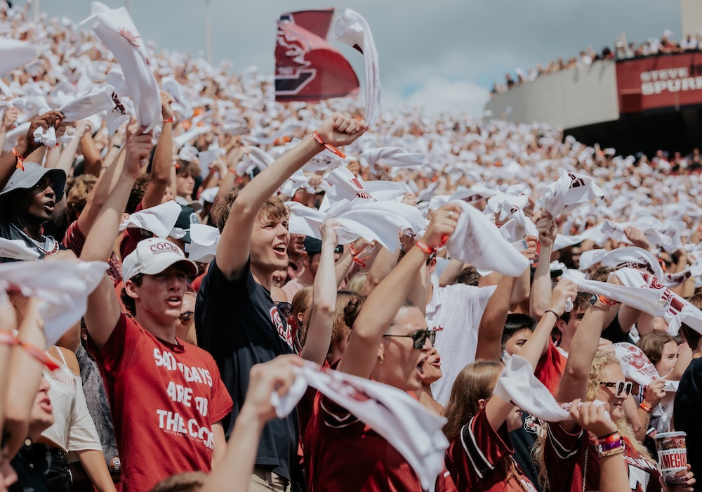 students at Williams-Brice waving white towels