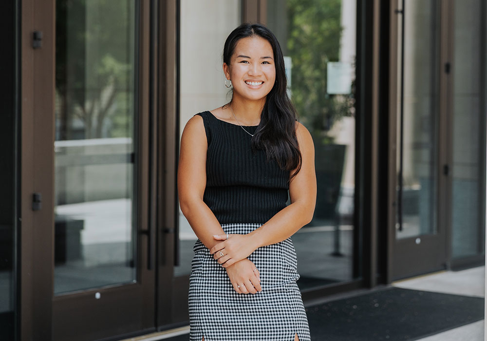 woman standing in front of the Joseph F. Rice School of Law