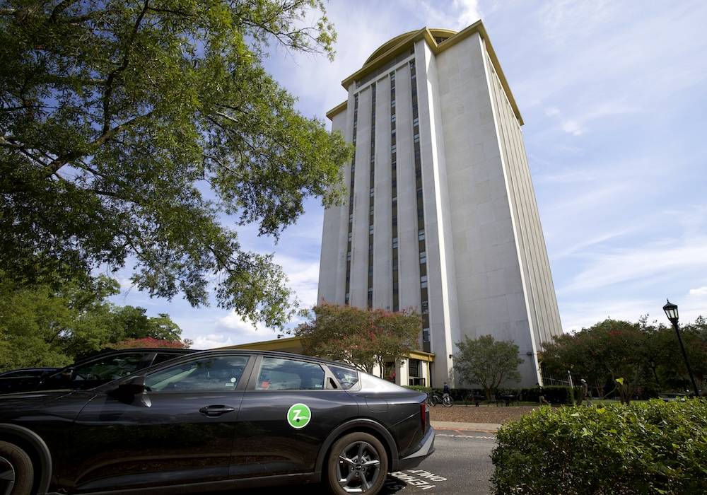 car with zipcar logo parked behind capstone