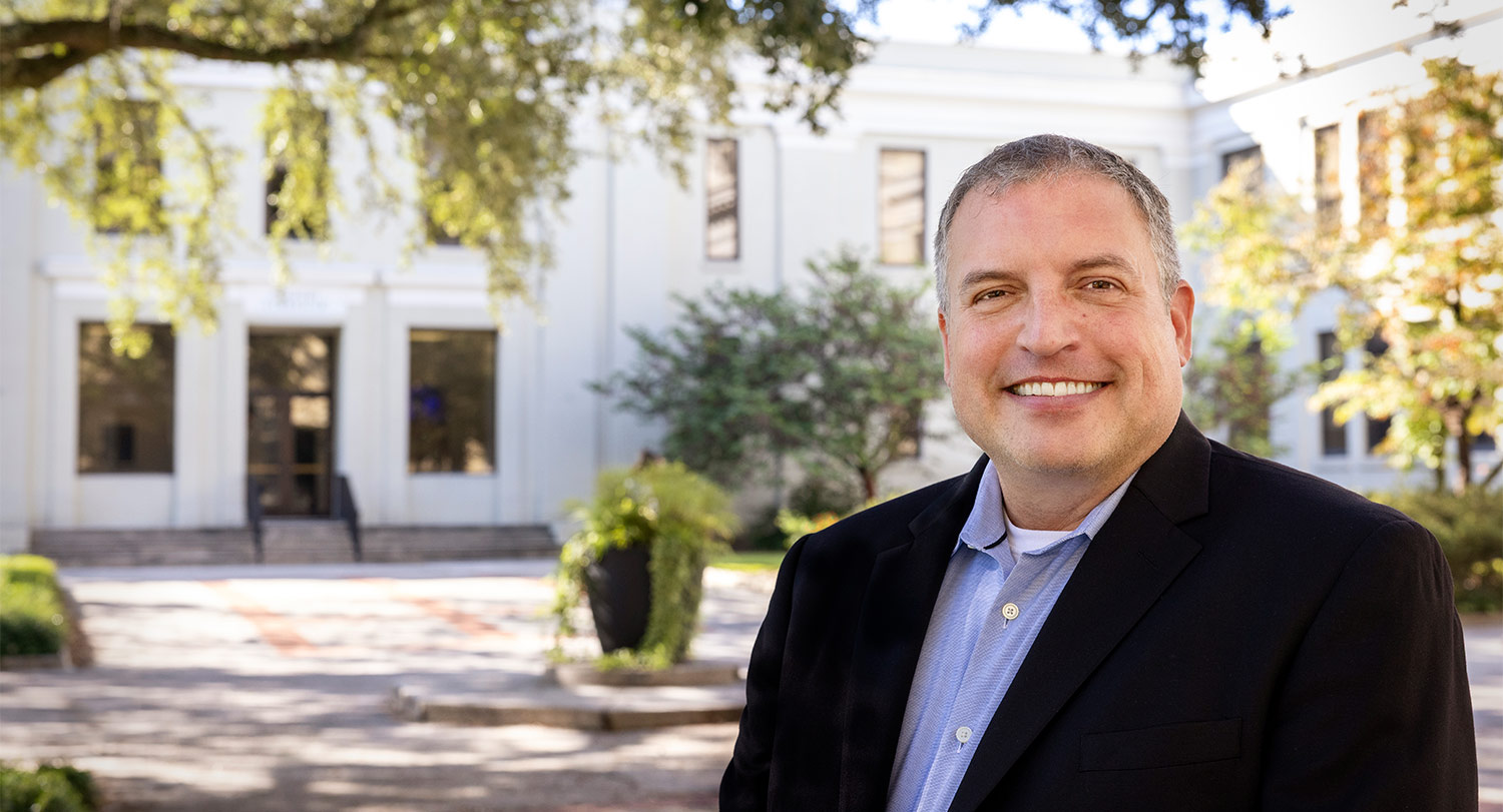Chris Burkett stands in front of the USC College of Education