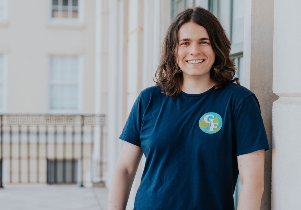 Person leaning against an exterior wall.