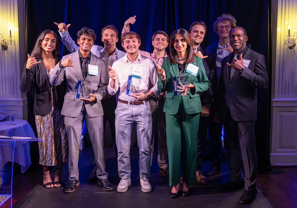 A group of winners gather with their awards.