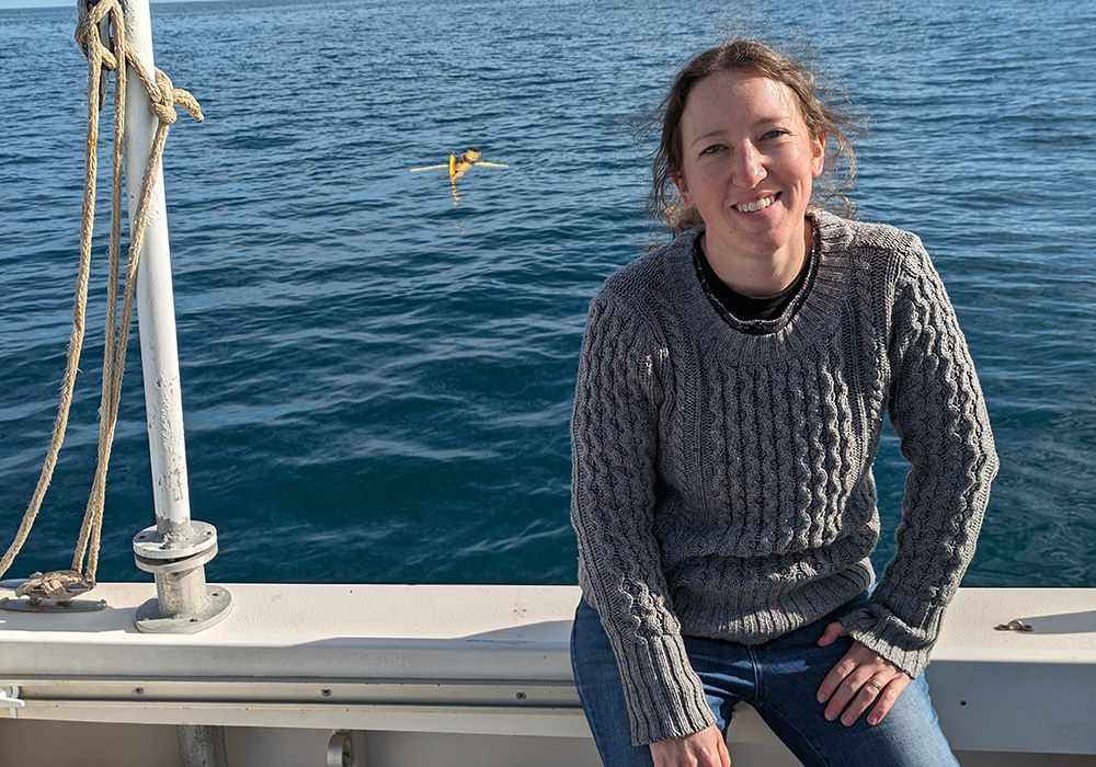 Woman on boat in the ocean with sensor visible in water behind her