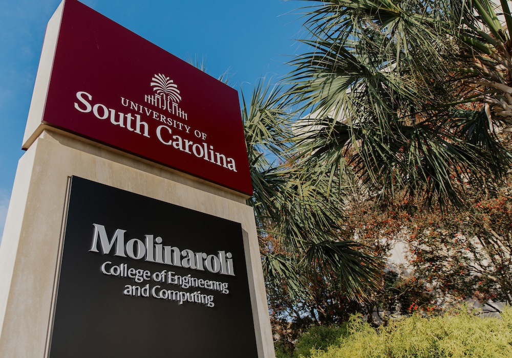 garnet sign reading "university of south carolina" above a black sign reading "molinaroli college of engineering and computing"