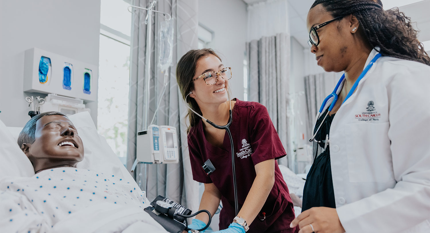 Nursing student with instructor at bedside