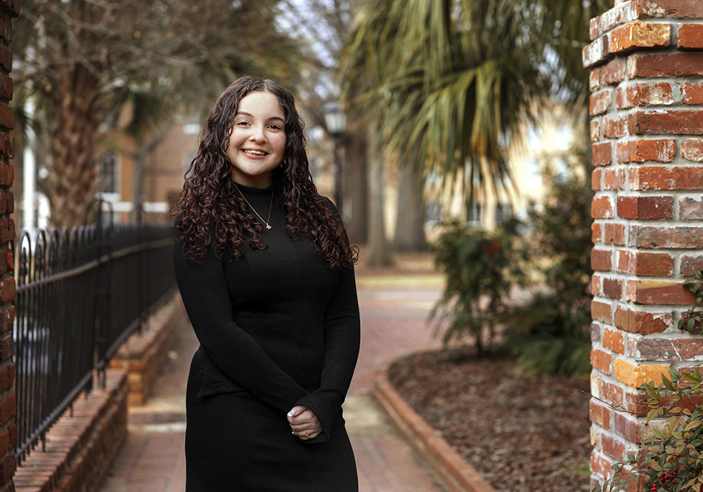 Headshot of Samantha Hinton in front of gates