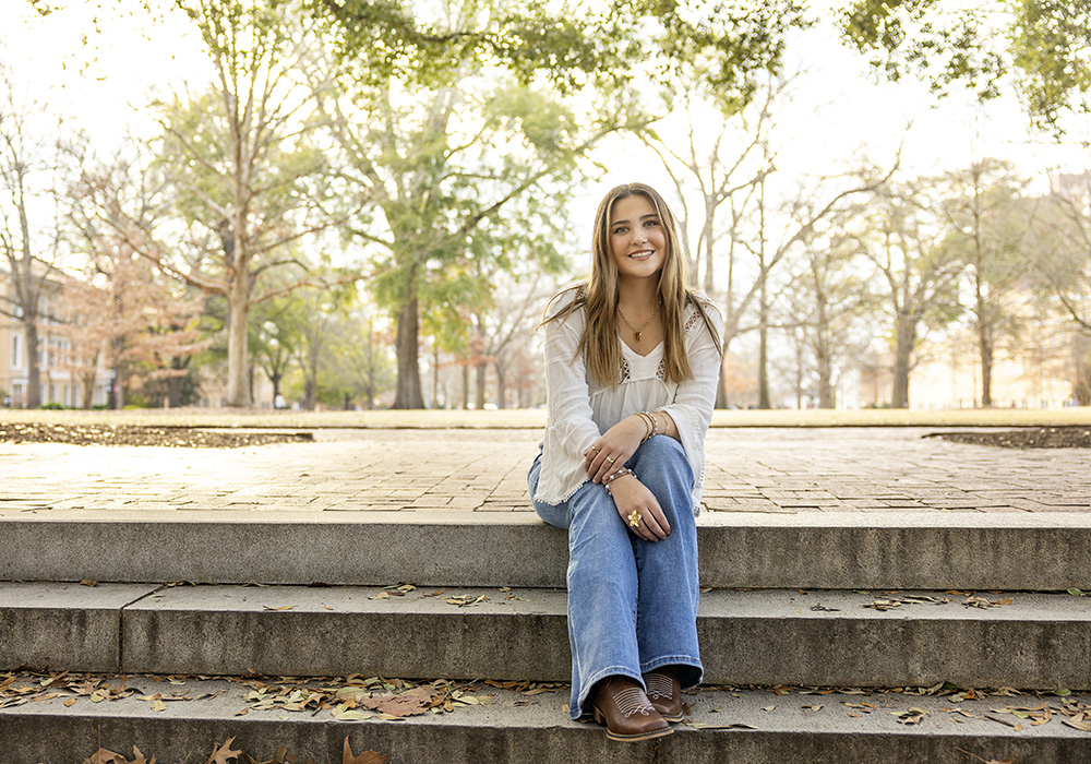 Teagan Thomas sits on steps near USC's historic horseshoe.