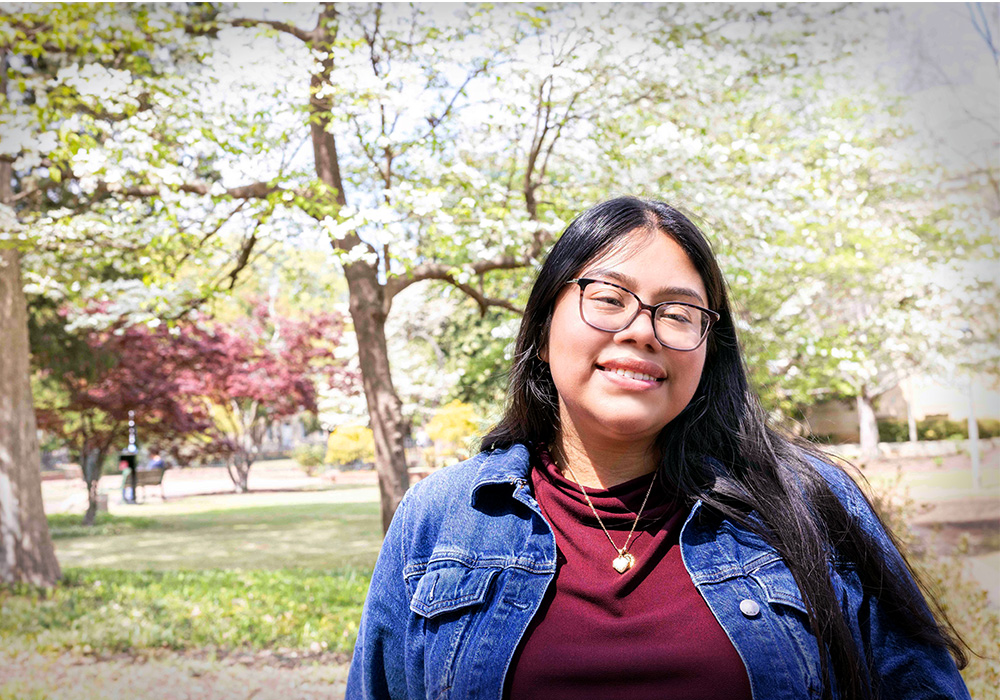 Michelle Ayala-Perez smiles while outside on USC's historic Horseshoe