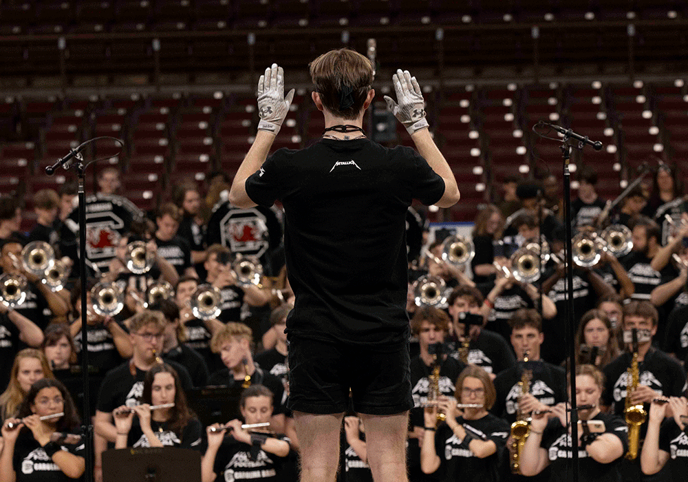 The Carolina Band drum major leads the band at Colonial Life Arena.