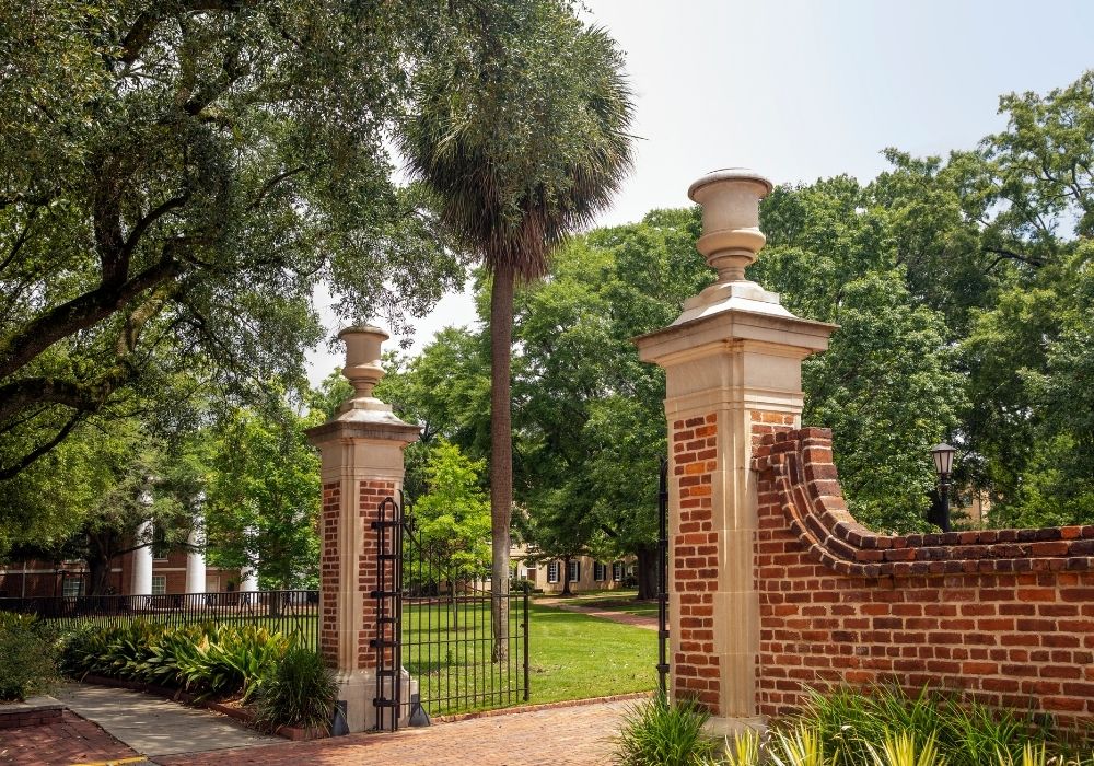 Historic brick gates and a curved brick wall frame campus