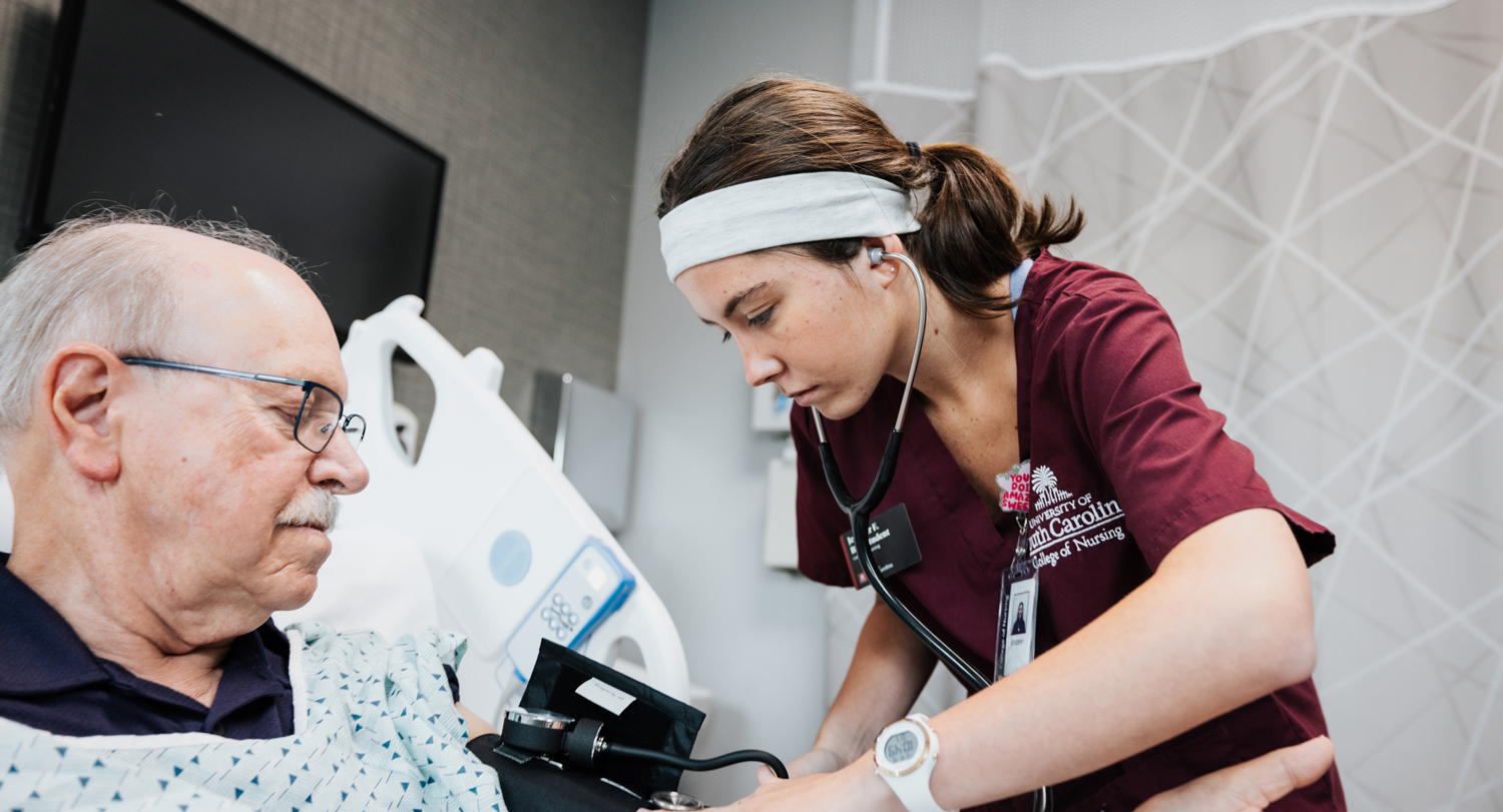 USC College of Nursing student takes a patient's blood pressure during a clinical simulation.