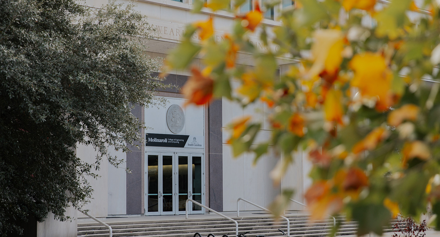 Exterior of USC's Swearingen Engineering building with fall foliage in the foreground