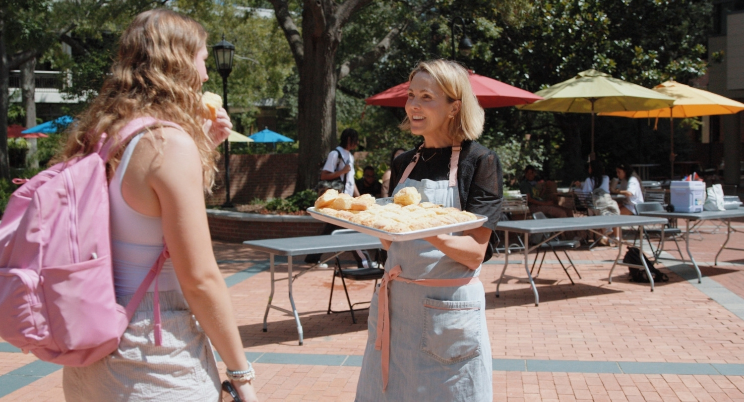 Carrie Morey passes out biscuits outside of Russell House on USC's campus