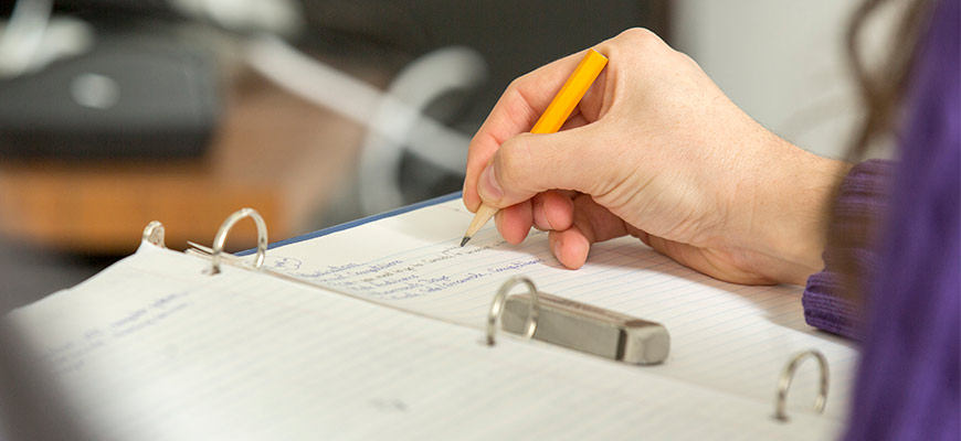 A student taking notes in class.